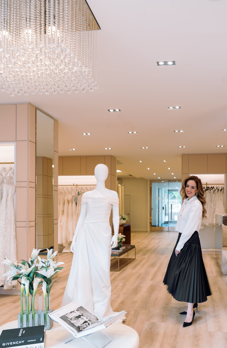 image shows sareh nouri standing next to a mannequin in a glamorous wedding dress in new york