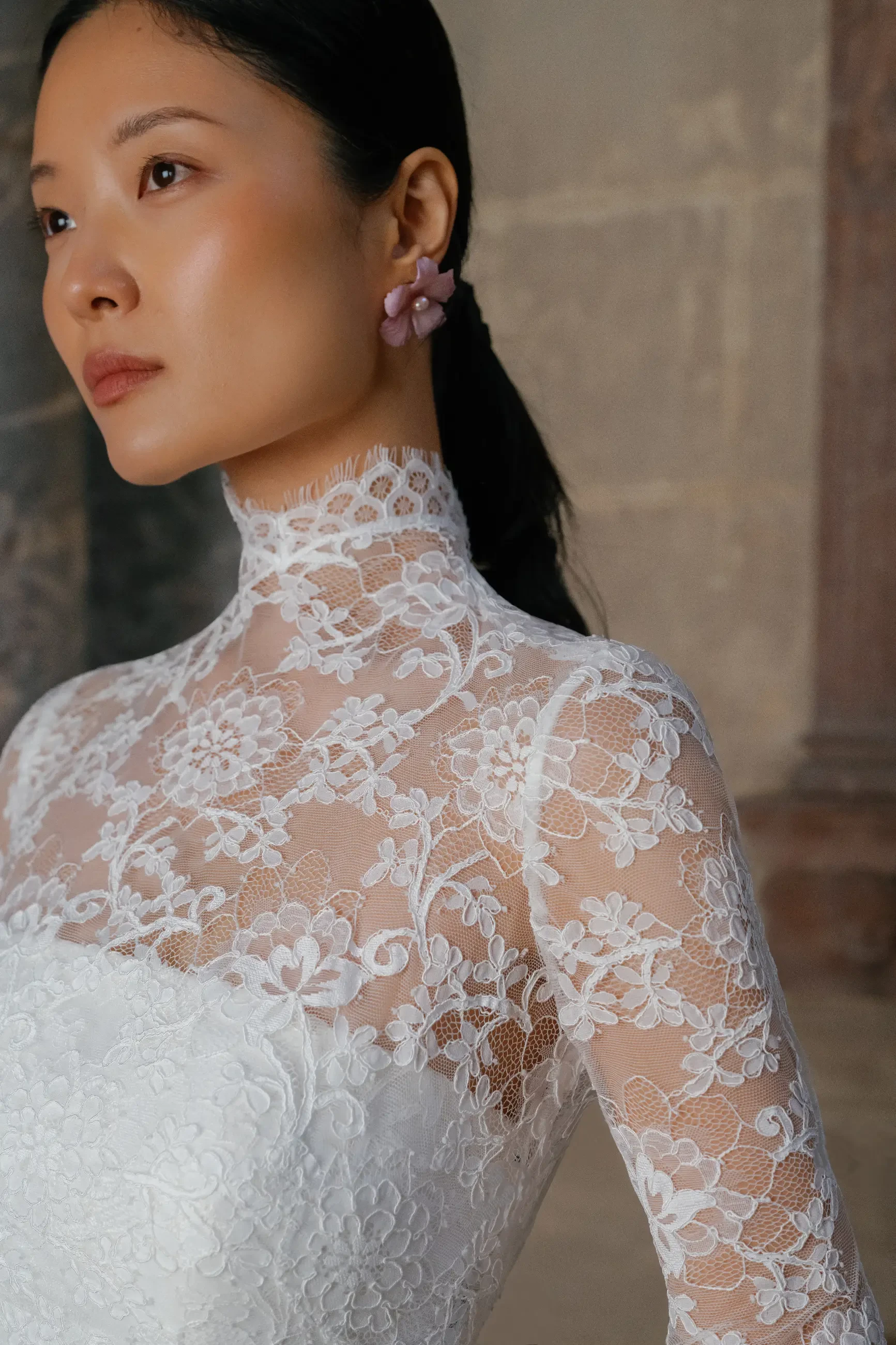 model is wearing a long sleeve lace wedding dress