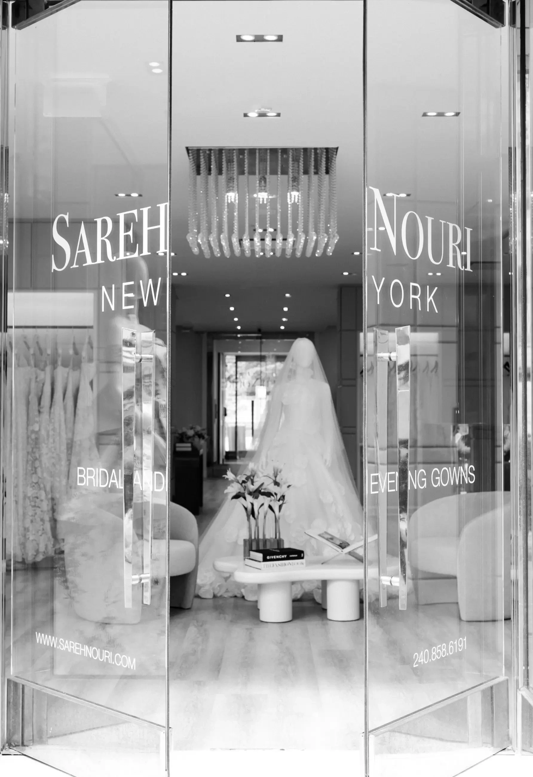 image shows the entrance of sareh nouri new york with the doors open and a mannequin wearing a wedding dress