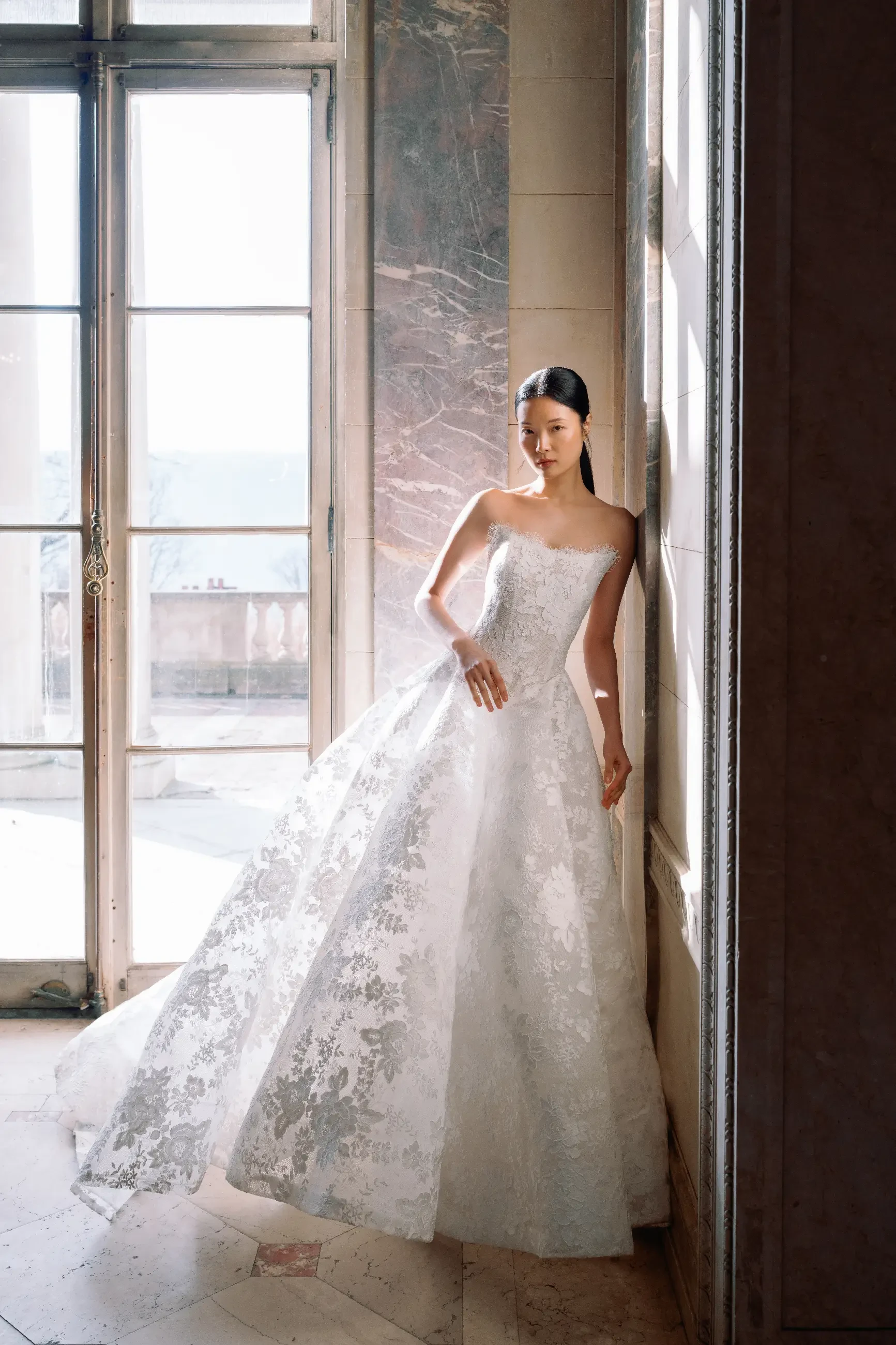 model is wearing a strapless lace wedding dress