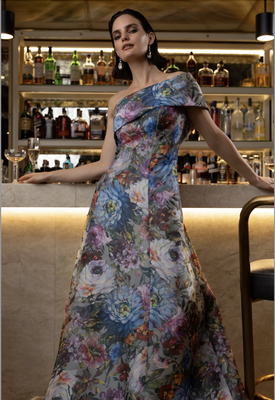 Model is wearing an A-line floral printed evening gown by sareh nouri