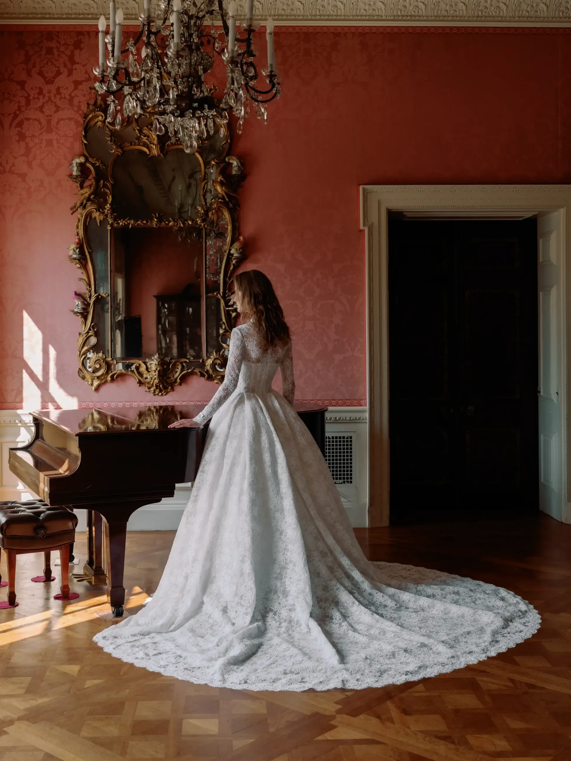 model wears a long sleeve lace ball gown