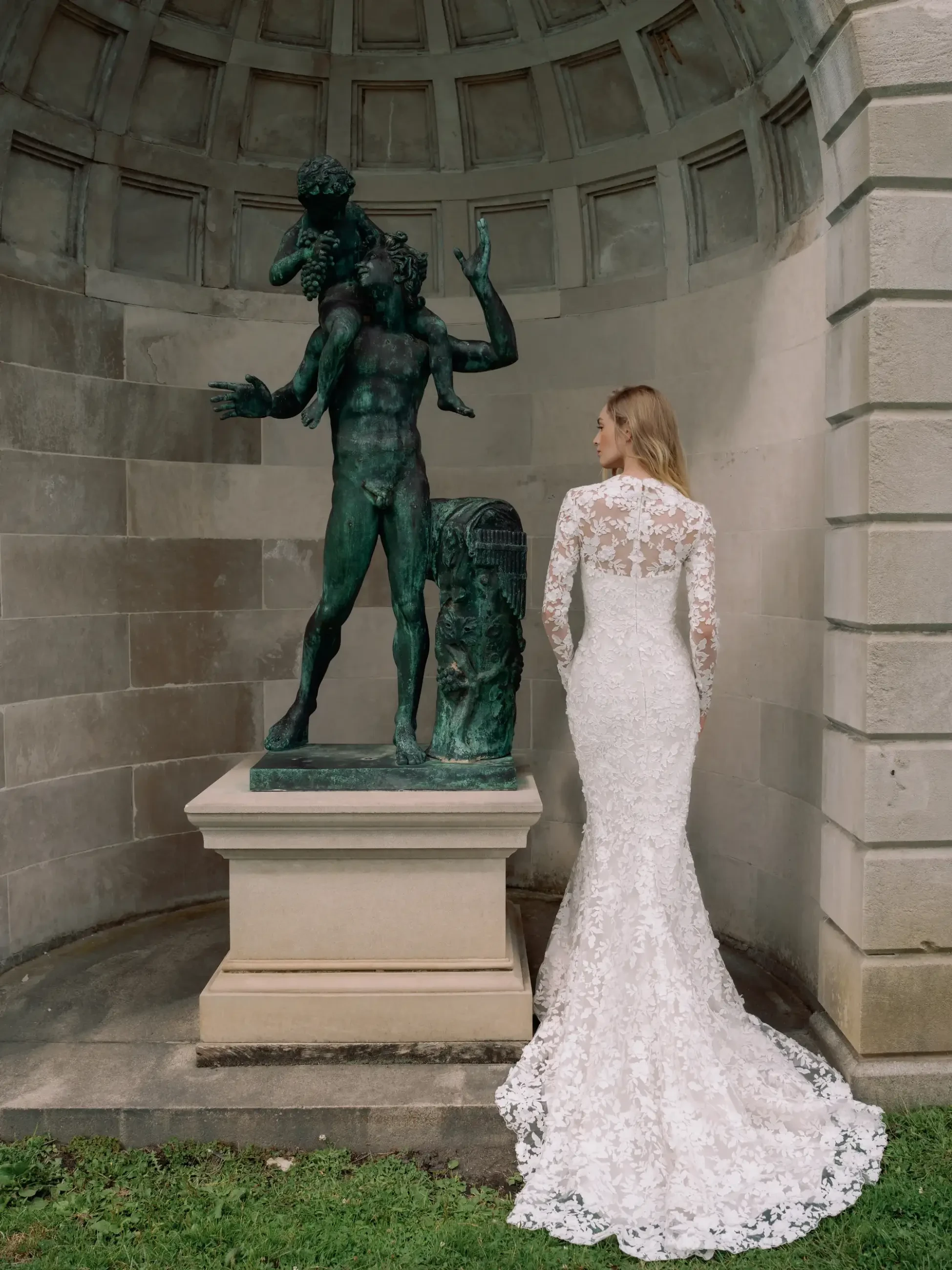 Model is wearing a square neckline fit and flare wedding dress