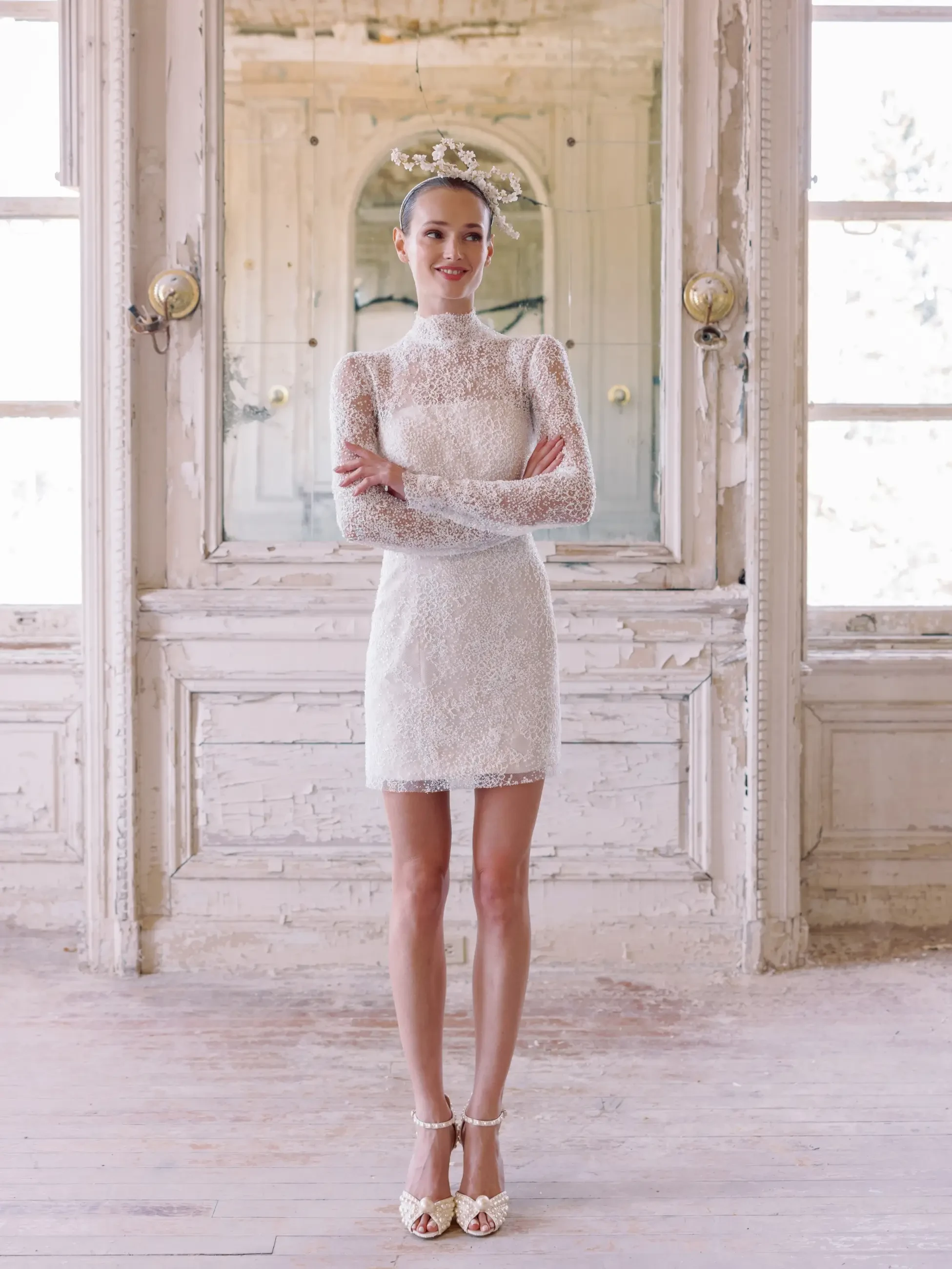 model wears a high neck long sleeve mini bridal gown
