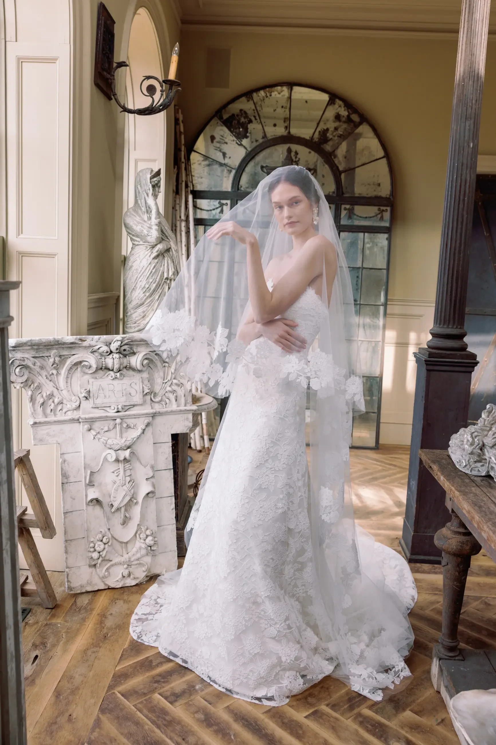 Model is wearing a modified A-line gown adorned with embroidered hydrangea lace and a romantic sweetheart neckline, perfect for a timeless bridal look.