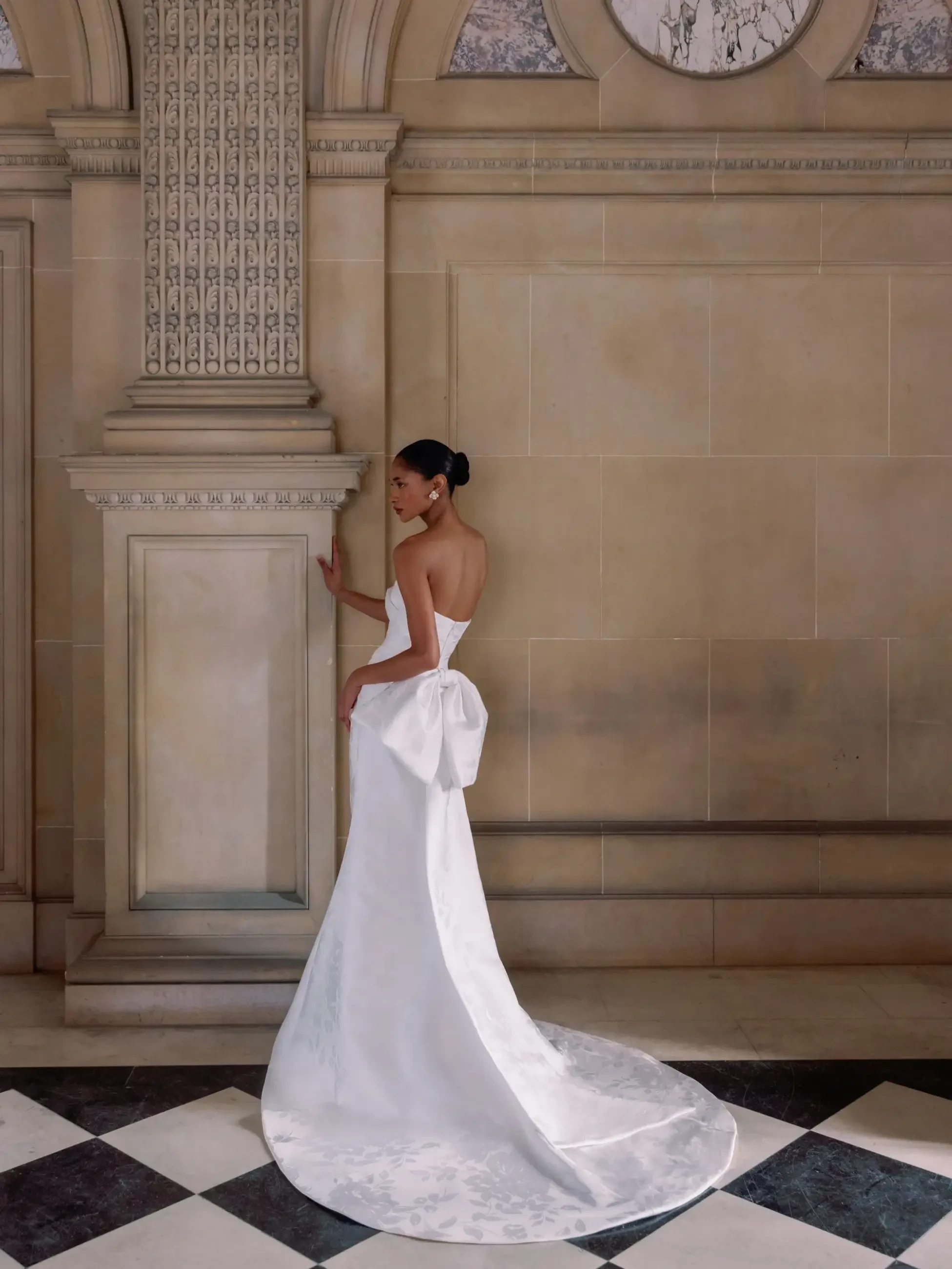 model is wearing a strapless slim flare wedding dress