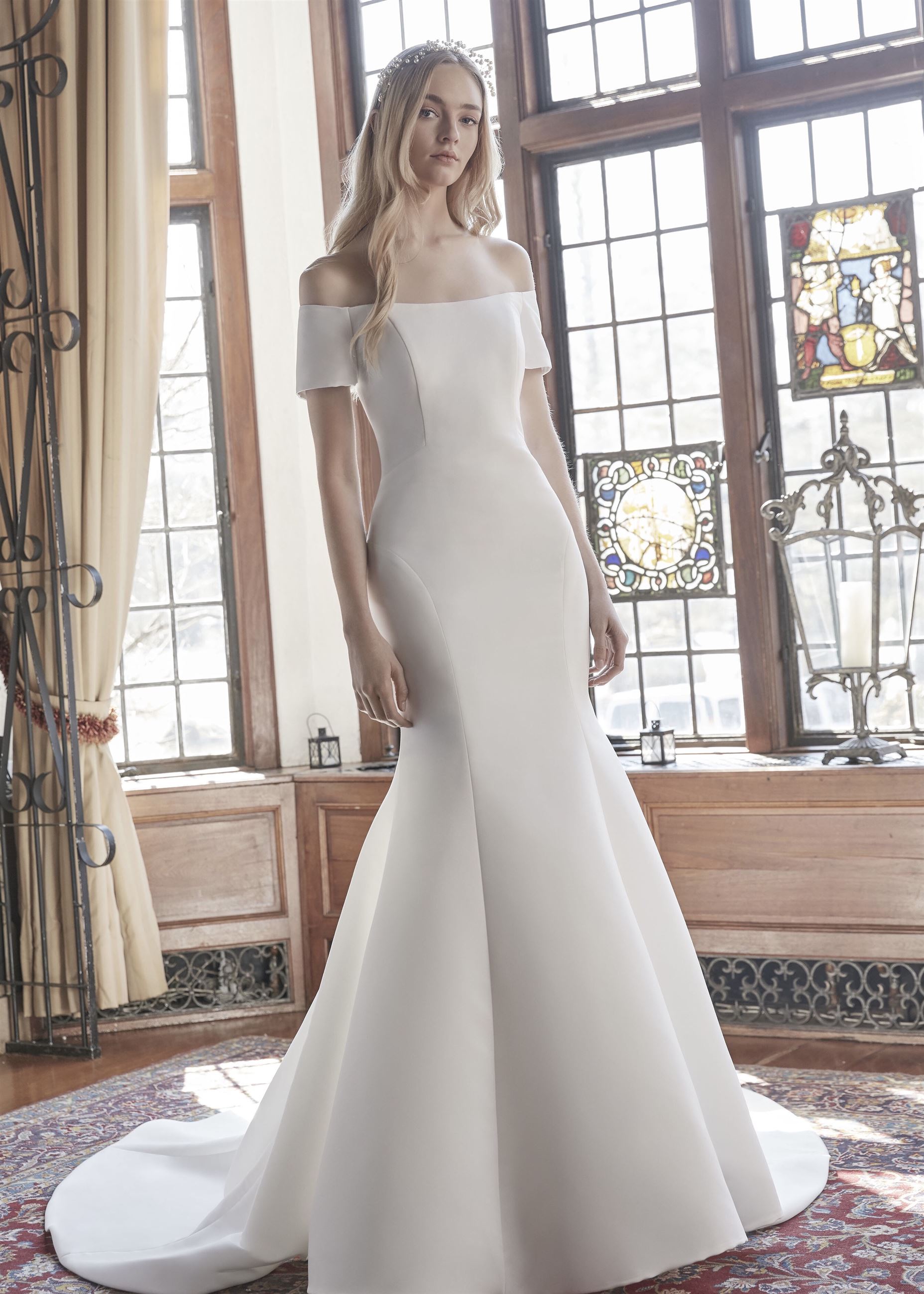 Model wearing a trumpet wedding dress