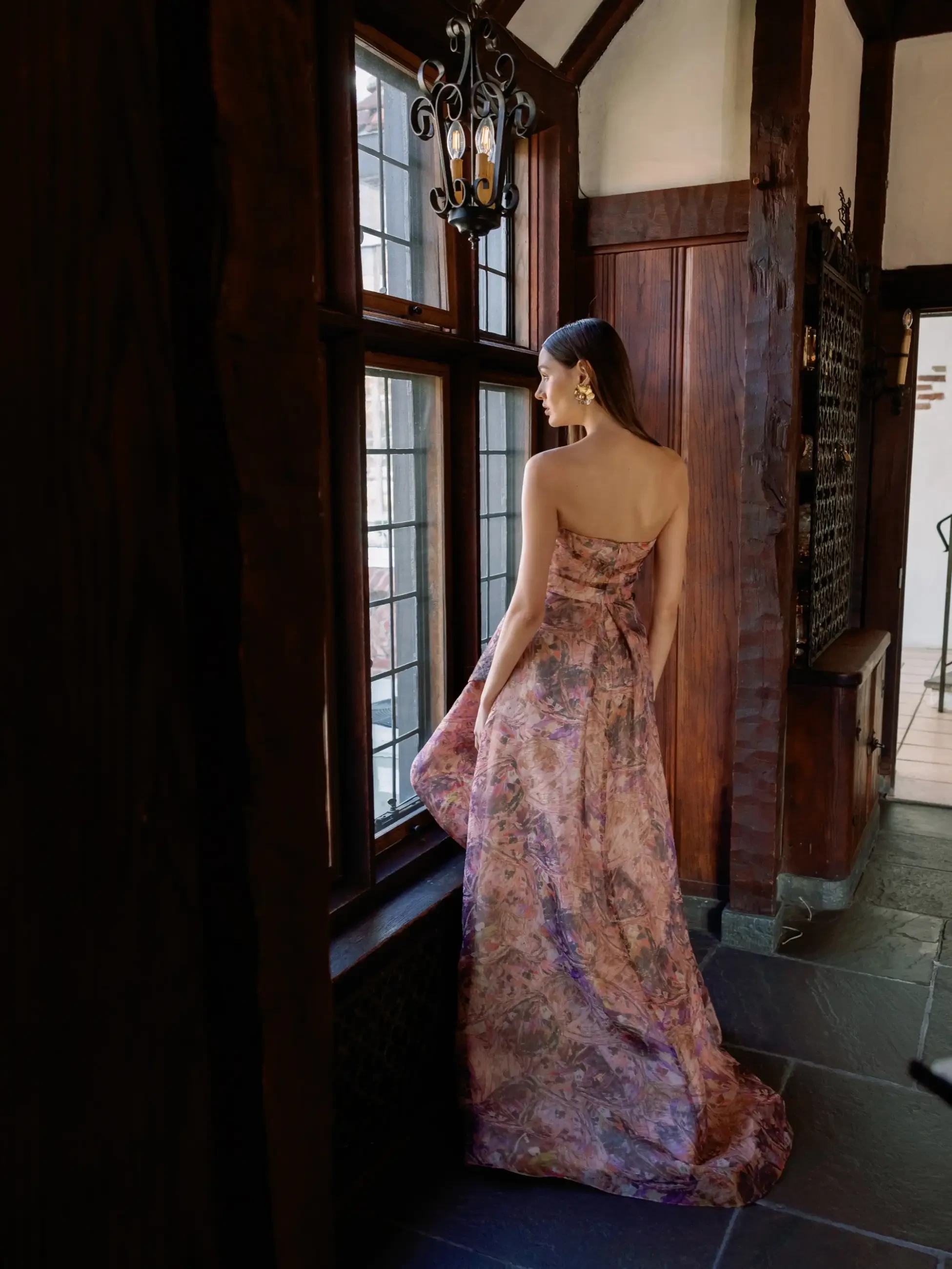 Model is wearing a metallic chiffon A-line evening gown by sareh nouri
