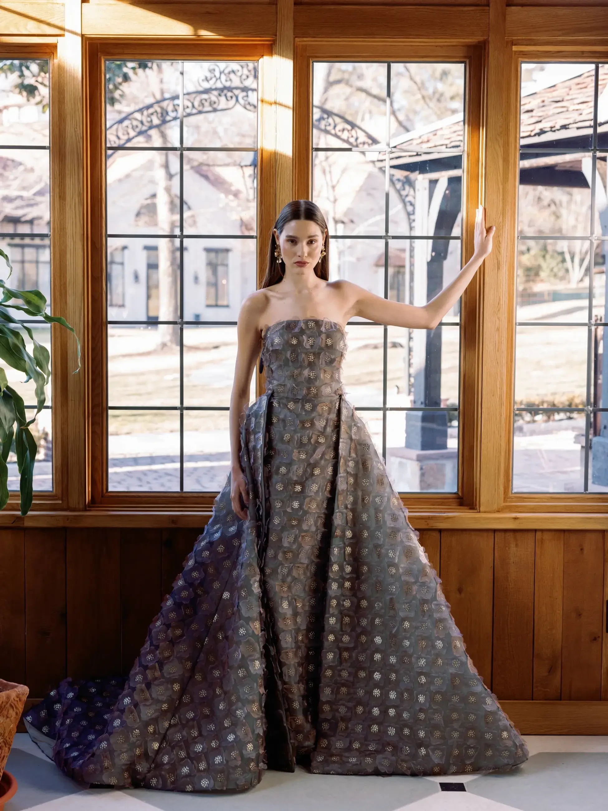 Model is wearing a printed organza column evening gown by Sareh Nouri