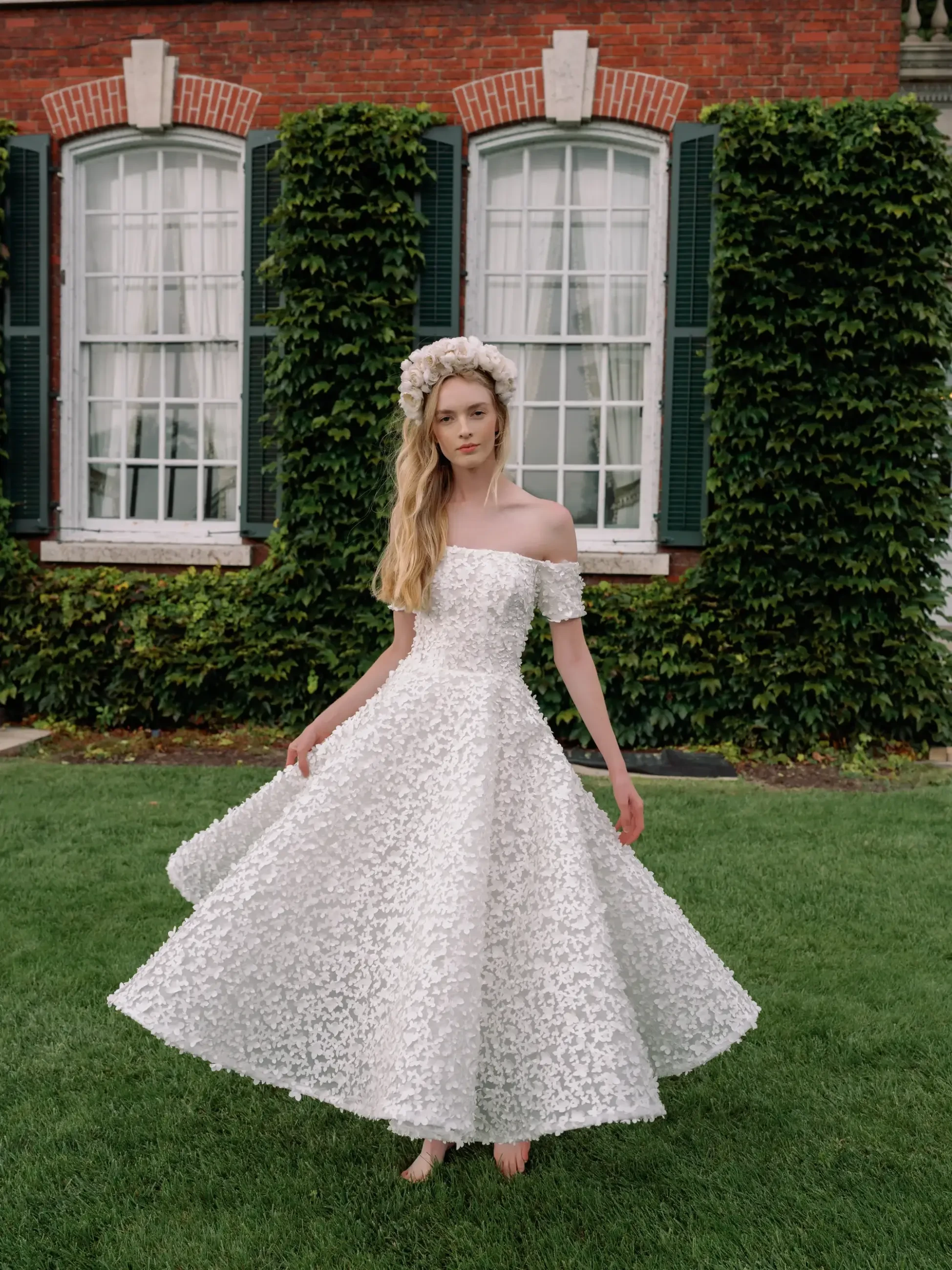 Model is wearing a lace straight neckline off the shoulder tea length dress