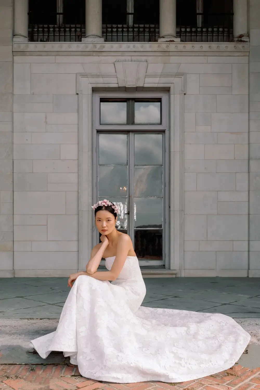 model is wearing a strapless fit and flare bridal gown
