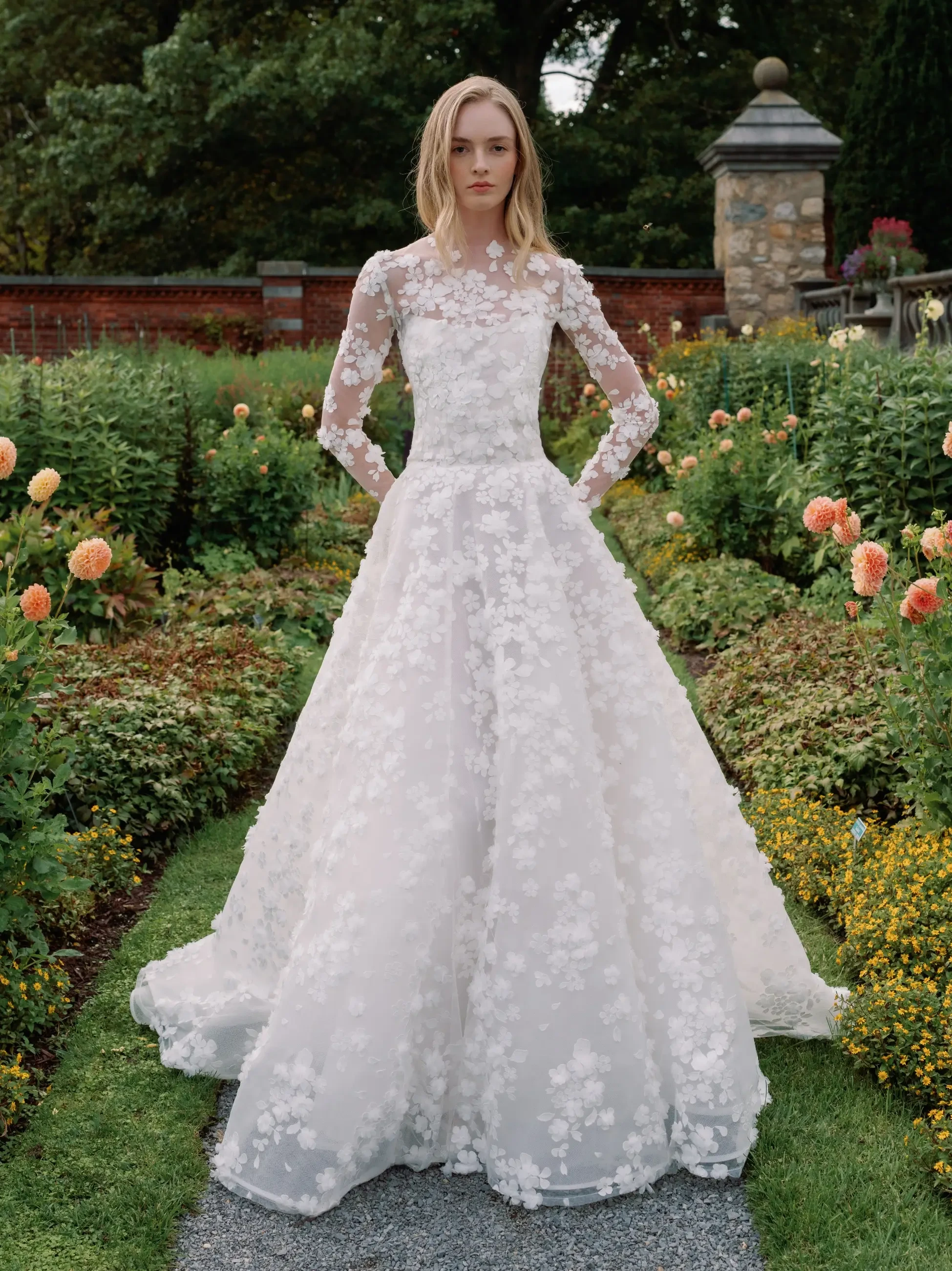 Model is wearing a ball gown wedding dress with a detachable long sleeve bolero