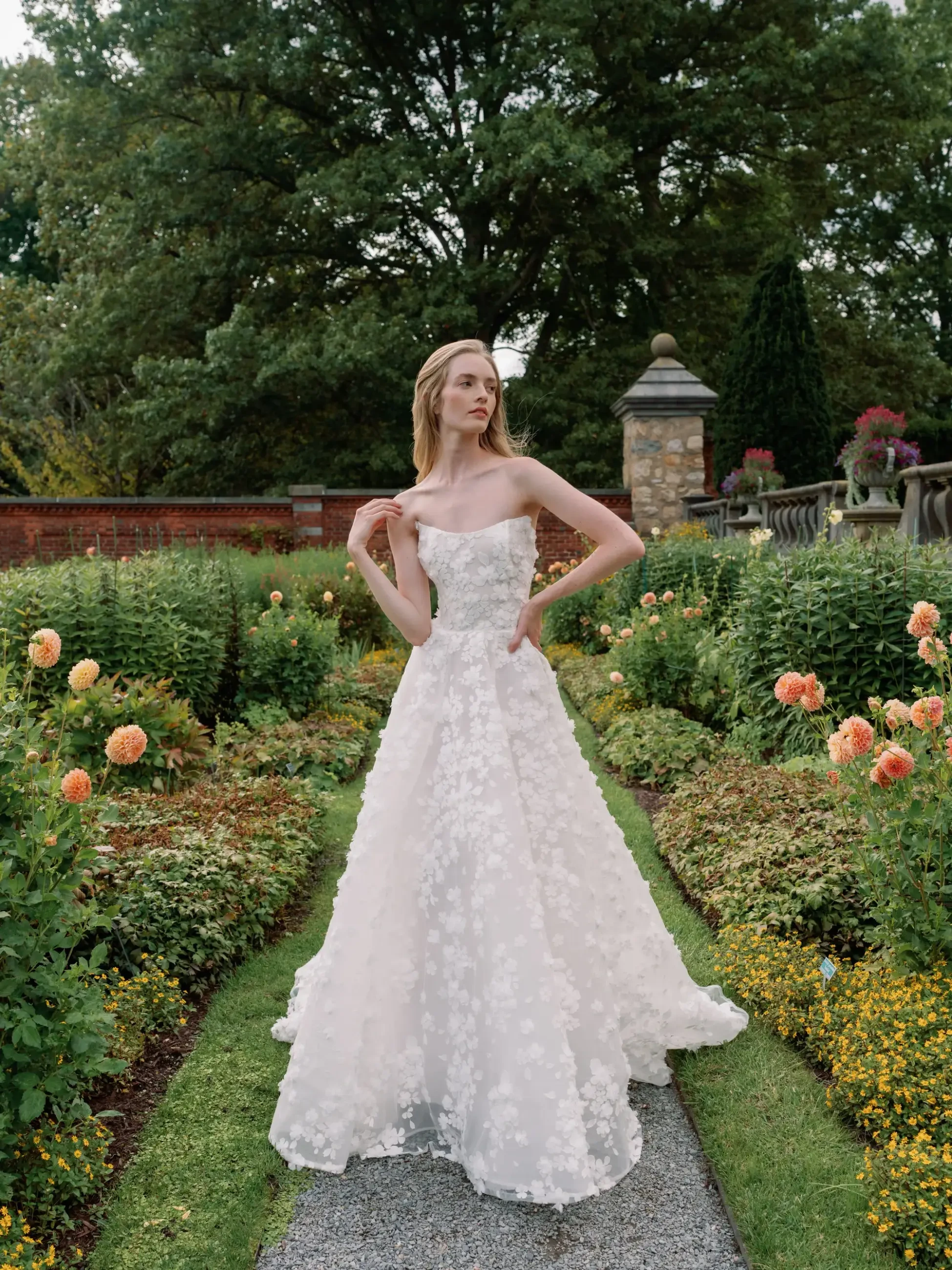 Model is wearing a ball gown wedding dress with a detachable long sleeve bolero