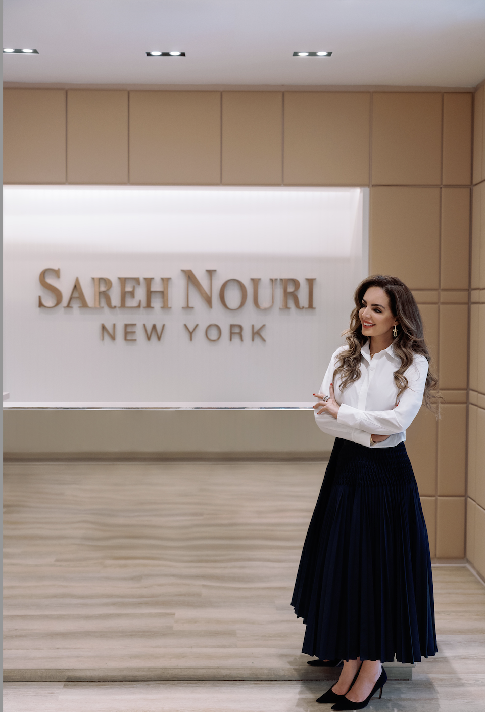 image shows sareh nouri smiling in her bridal boutique in new york