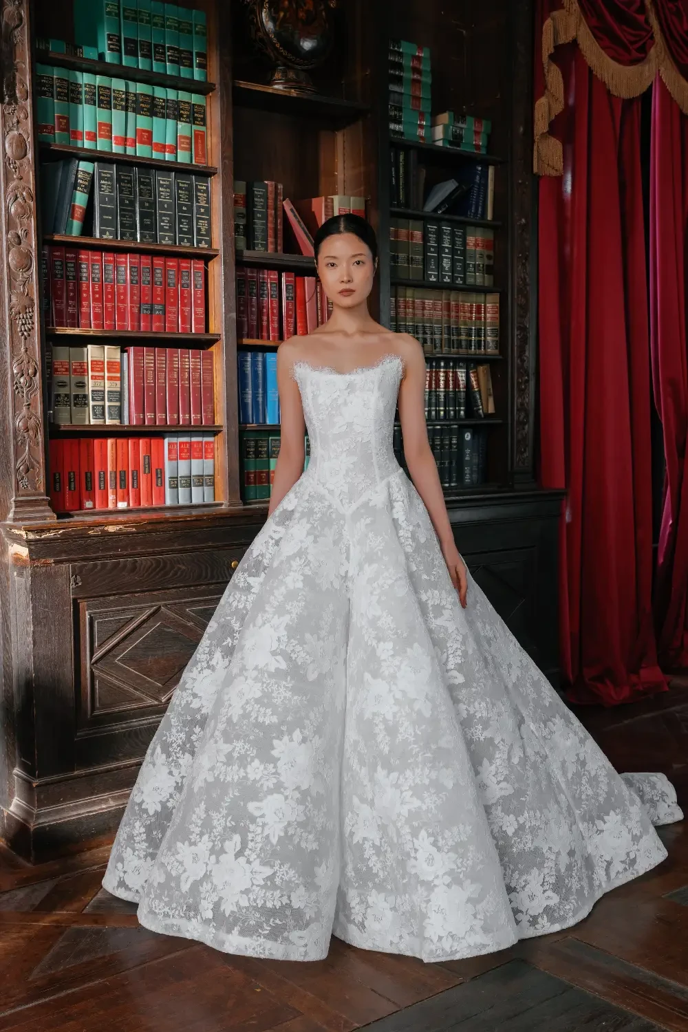 model is wearing a strapless bridal gown with detachable neckline piece