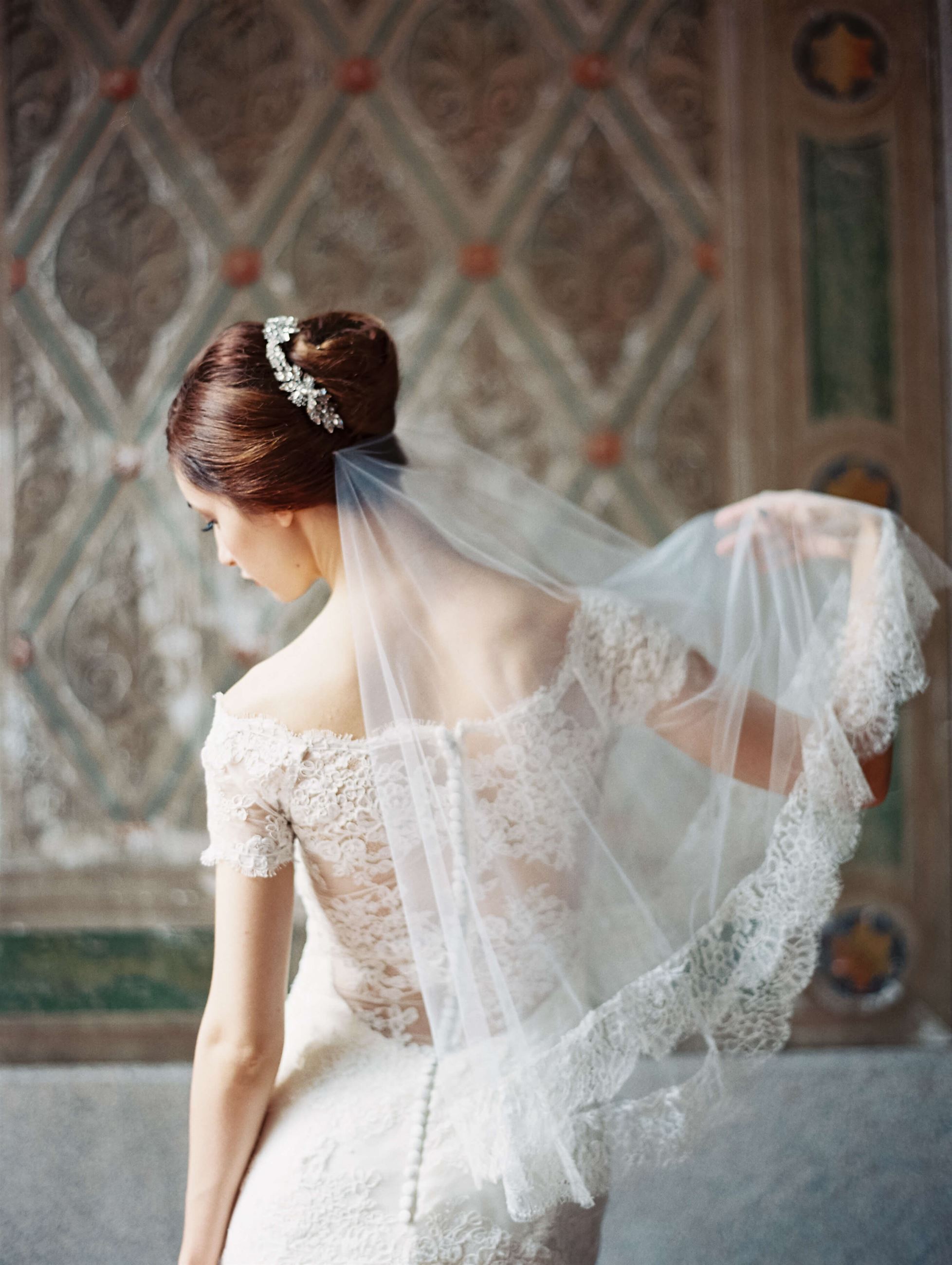 Photo of the model wearing bridal gown near the wall