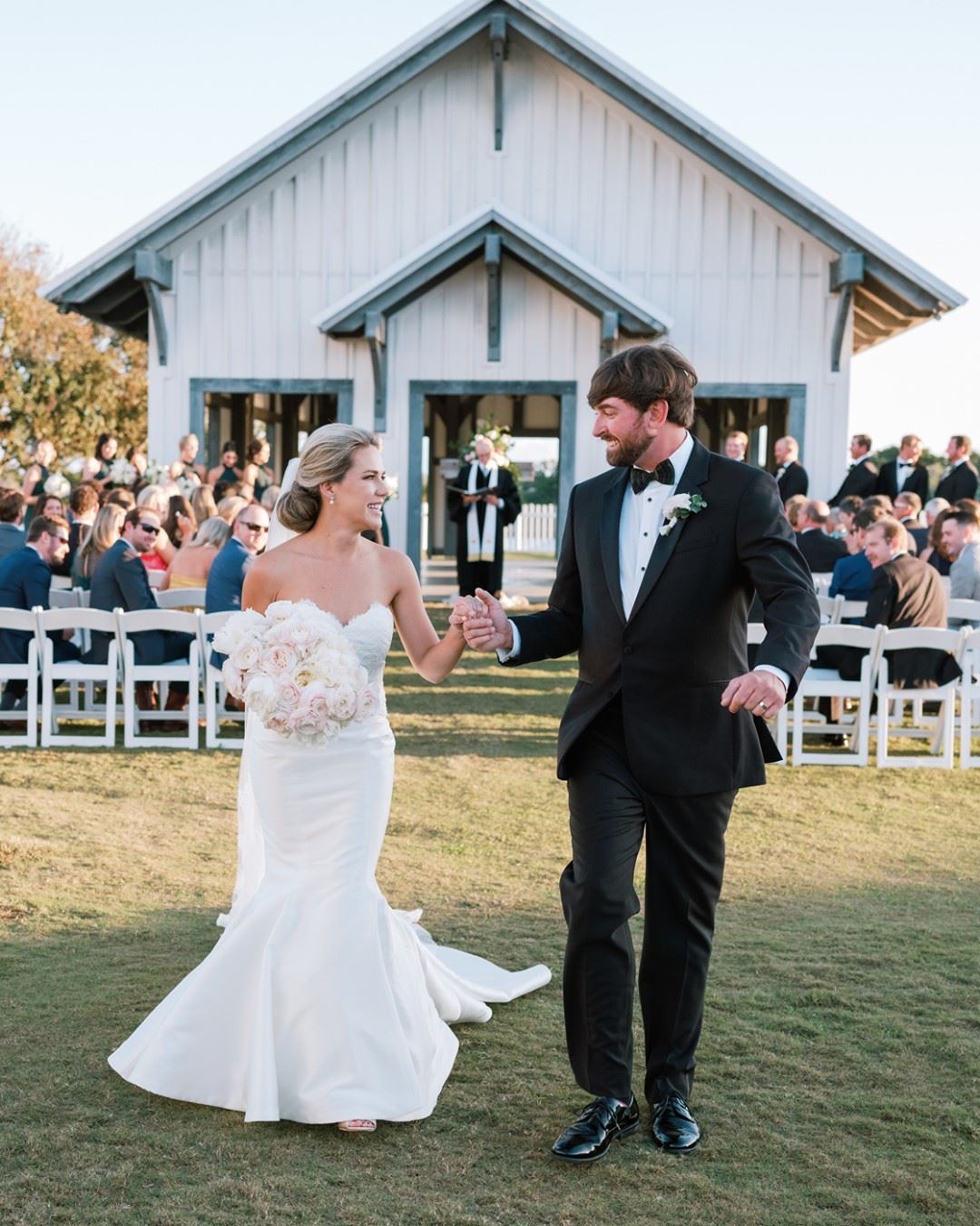 Photo of the real bride and groom near the building