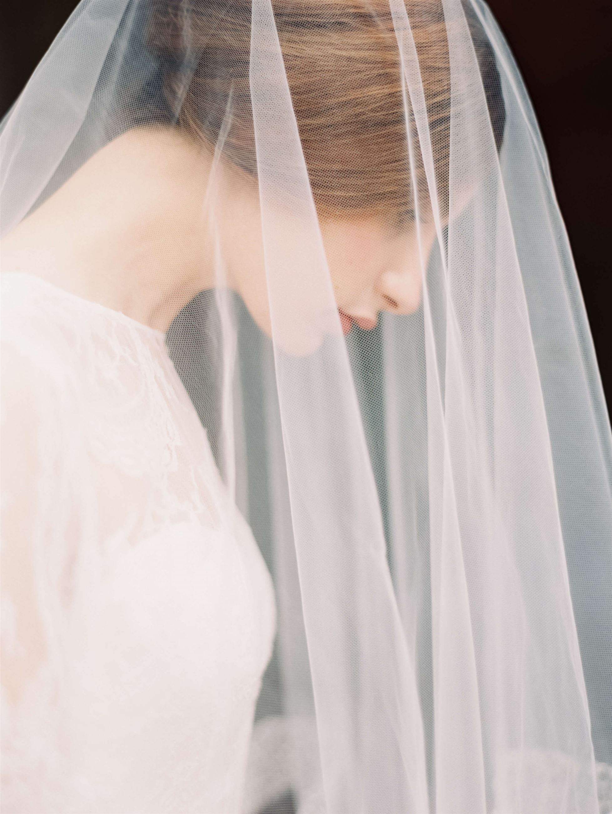 Photo of the model wearing white bridal gown under the veil